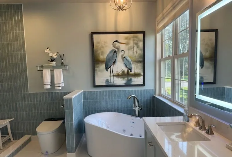 Bathroom by Tile Craft Artisans with blue-green wall tile, a freestanding tub and a white veined floor.